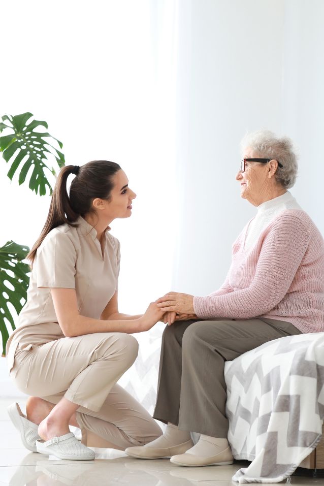 caregiver holding elderlys hands