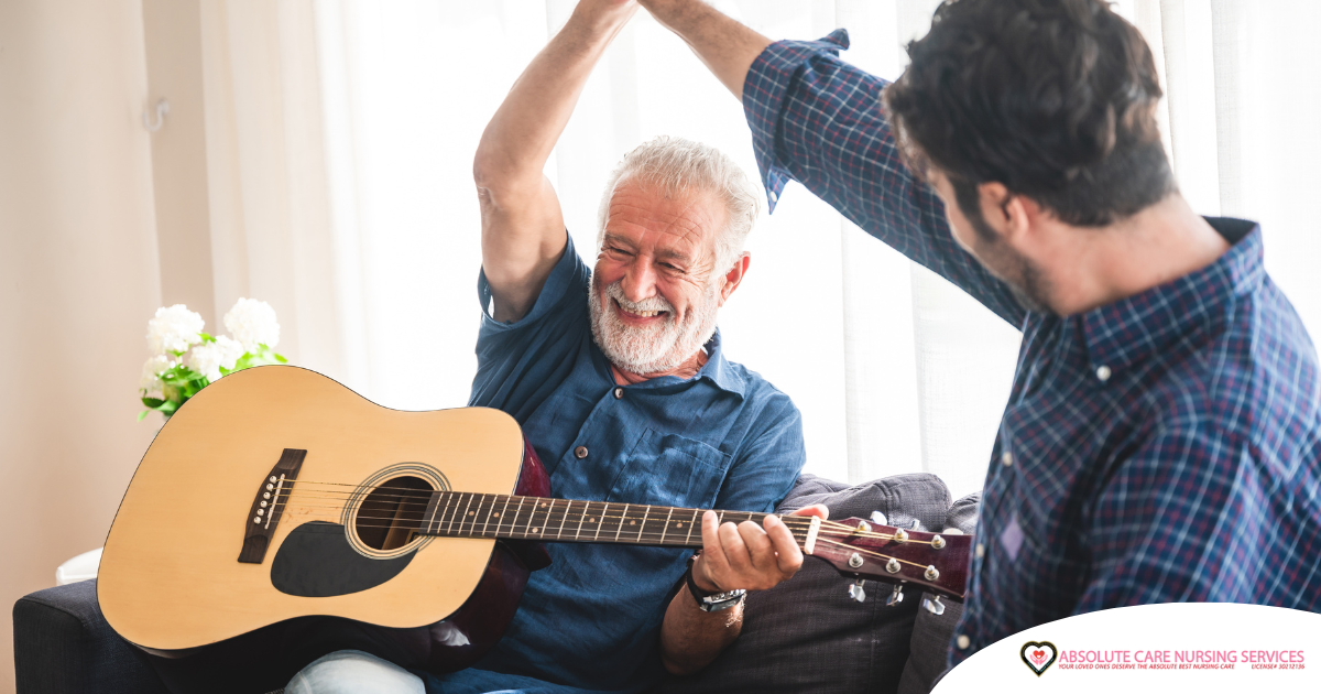 A smiling son high fives his happy elderly father as he plays the guitar, showing the positive effect music can have on people, including those with dementia.